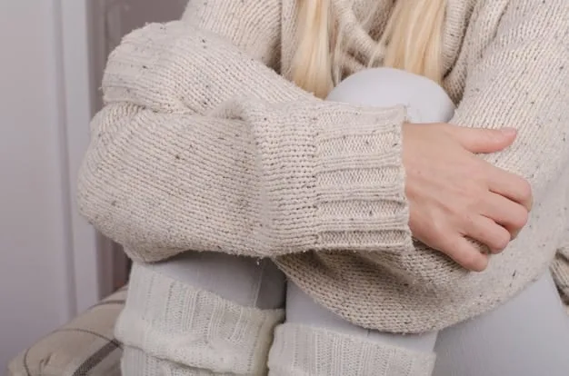 A close-up shot of a woman's outfit detailing the luxurious texture of a cashmere sweater paired with the sleek fabric of wide-leg silk trousers. Emphasis is on showcasing comfort and high-quality materials.