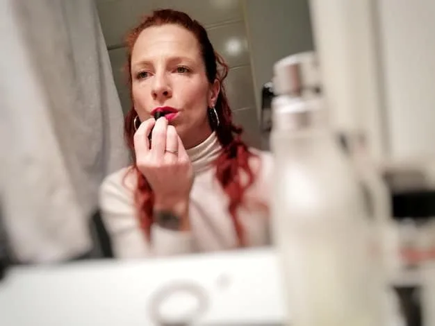 A woman applying nude lipstick while looking in the mirror. The focus is on capturing the simplicity and elegance of nude lipstick, as well as the process of applying it flawlessly.