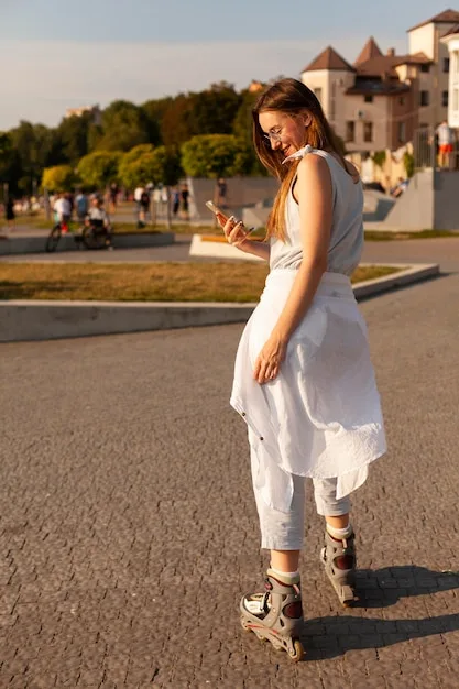 A street style photo of a curvy woman confidently walking down the street in a vibrant, knee-length dress. The dress has a bold floral print and is cinched at the waist with a stylish belt. She is wearing strappy sandals and sunglasses, exuding effortless style and self-assurance.