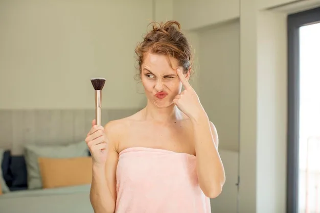 A woman demonstrating the application of blush on her cheek with a makeup brush, showcasing the technique for achieving a natural and radiant look in a quick makeup routine.