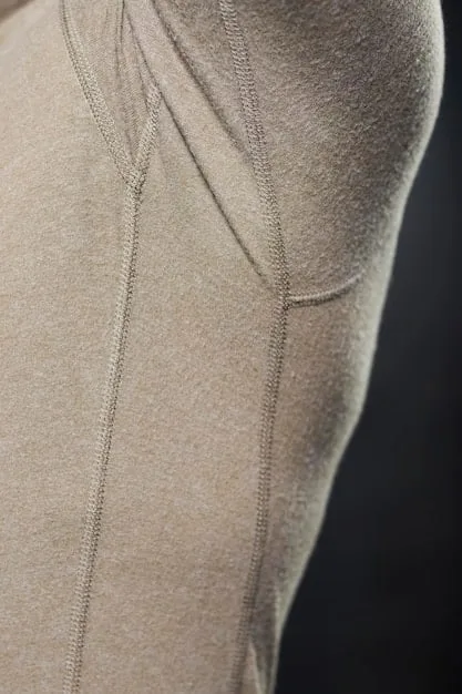 A close-up shot of high-quality athleisure fabric showing texture, stitching, and technical details that offer both comfort and durability. The fabric is a blend of natural and synthetic fibers, highlighting the attention to performance and style.
