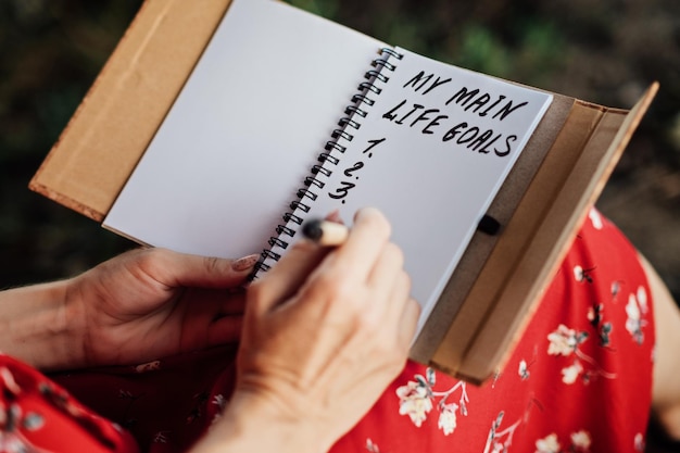 A close-up of a journal with affirmations written in neat, inspiring handwriting. A pen rests beside it, suggesting regular use.