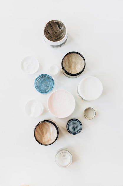 Close-up shot of a diverse group of skincare products, including serums, moisturizers, and exfoliants, arranged on a clean, white surface with soft, natural lighting.