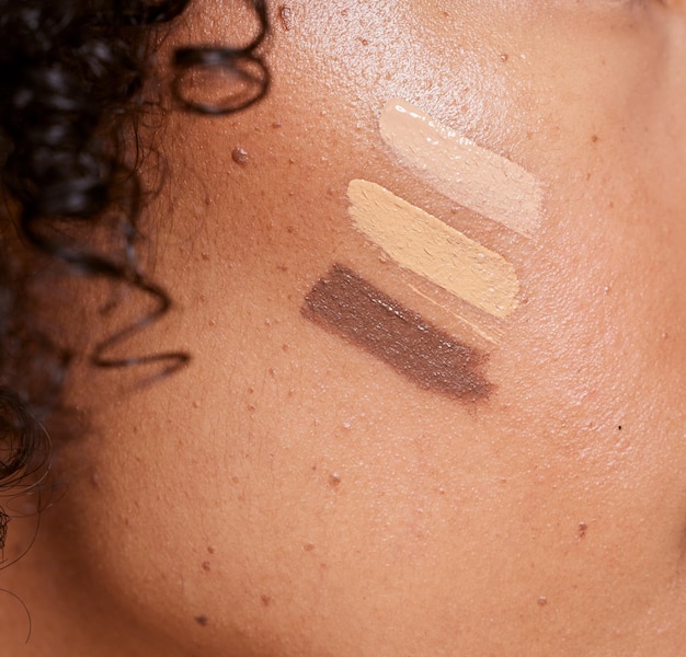 A close-up image showing a variety of foundation swatches on different skin tones, highlighting how the same shade can appear differently based on skin color and undertone.