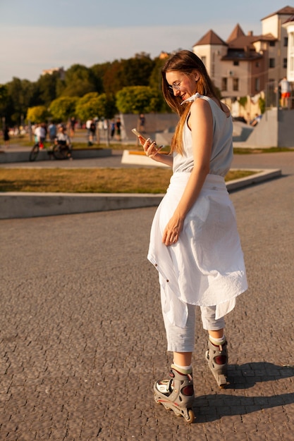 A street style photo of a curvy woman confidently walking down the street in a vibrant, knee-length dress. The dress has a bold floral print and is cinched at the waist with a stylish belt. She is wearing strappy sandals and sunglasses, exuding effortless style and self-assurance.