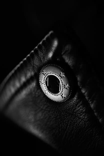 A close-up shot of a black blazer showing the texture of the fabric and the details of the buttons and stitching.
