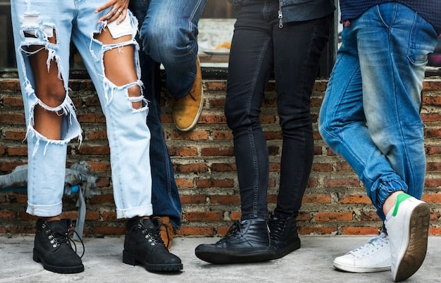 Assorted types of footwear (sneakers, boots, loafers) paired with different styles of jeans, showcasing the variety of options and combinations.
