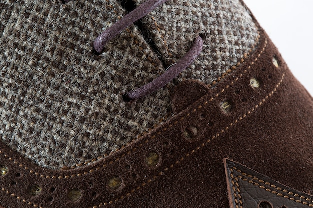A close-up shot of various casual shoe materials, including leather, canvas, and suede. The shot highlights the texture and detail of each material, showcasing their unique qualities.