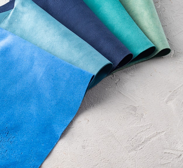 A close-up shot of various fabric swatches in complementary color pairings such as blue and yellow, green and purple, red and teal. The swatches are arranged in an artistic way, showcasing the harmonious contrast between these classic color combinations.