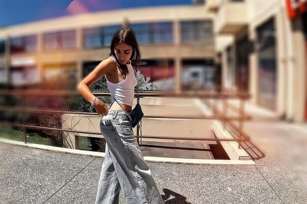 A model wearing sophisticated athleisure attire on a city street, showcasing a mix of high-quality leggings, a designer hoodie, and elegant sneakers. The outfit is accessorized with minimalist jewelry, highlighting how athleisure can be elevated for a fashionable look.