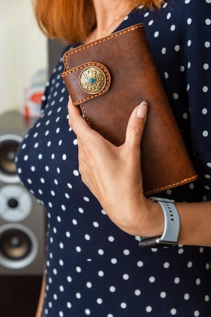 A close-up shot of a woman's hands holding a luxurious, unbranded leather handbag. The focus is on the texture and quality of the leather, highlighting the craftsmanship and attention to detail.