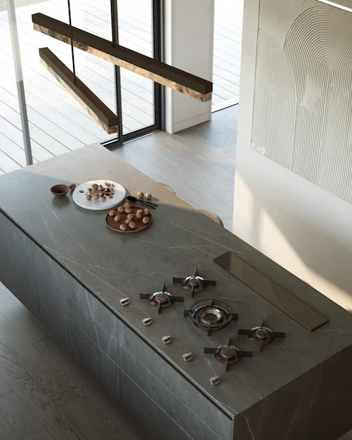 A picture of a sleek, minimalist kitchen with high-end appliances and natural stone countertops. There are no visible brand logos, emphasizing the quality and craftsmanship of the materials.