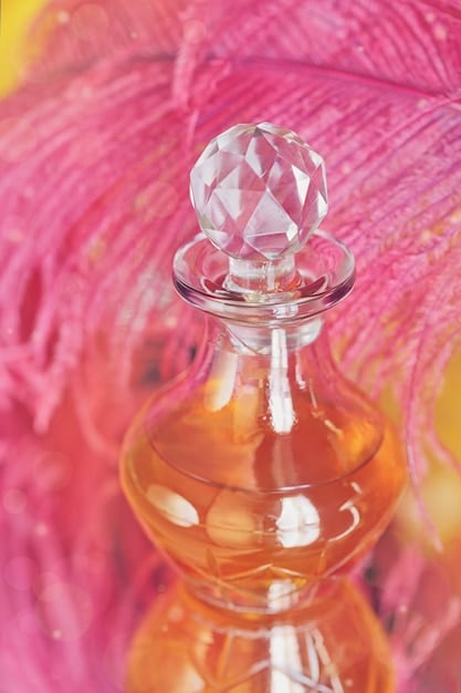 A close-up shot of a perfume bottle with a classic design (e.g., a Chanel No. 5 bottle) placed next to a neatly folded classic white shirt and a string of pearls. The lighting should be soft and elegant, highlighting the timeless appeal of both the fragrance and the fashion items.