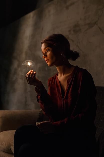 A woman in a glamorous WePink Shein evening gown is standing in a dimly lit setting, applying perfume to her wrist. The focus is on her elegant attire and the luxurious ambiance.