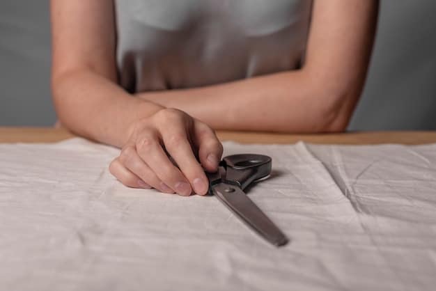 A close-up shot of a person's hands carefully cutting fabric with scissors on a table filled with various DIY fashion supplies, such as colorful threads, measuring tape, and design sketches. The focus is on the precision and creativity involved in the process.