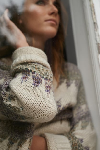 A close-up shot of a Shein oversized knit sweater paired with high-waisted leggings on a white background. The sweater is a neutral color (beige or light gray) and the leggings are black, showcasing the texture and comfort of the materials.