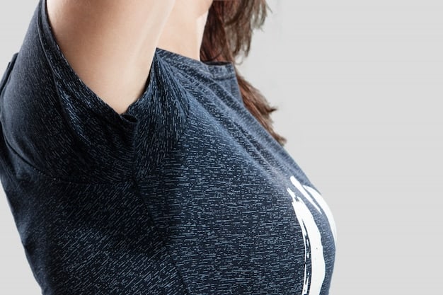 A close-up shot of a woman's athleisure outfit details, focusing on the texture of high-waisted leggings, a soft-knit cropped sweater, and fashionable white sneakers. The background is a blurred coffee shop interior.