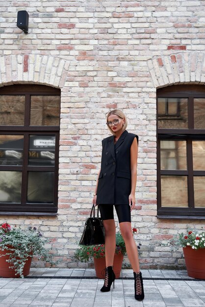 A woman in a Shein sheath dress being styled with a blazer for work, then transformed with a statement belt, heels, and bold jewelry for evening.