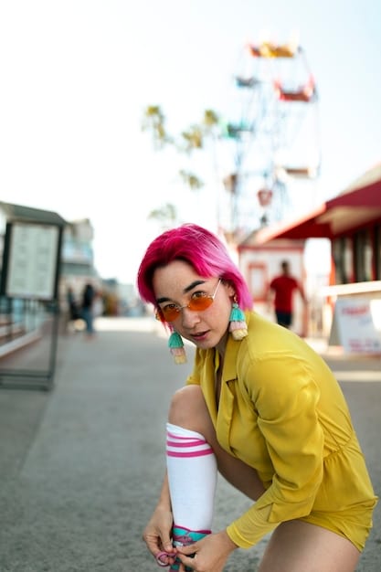 A street style photo featuring a woman wearing a color-blocked outfit. She is wearing a bright yellow sweater, paired with high-waisted pink trousers, and accessorized with white sneakers and a small blue handbag. She is walking down a city street, looking stylish and confident, embodying the essence of casual chic color blocking.