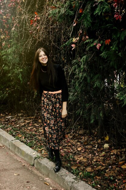 A Shein outfit featuring a fitted black turtleneck sweater paired with a flowy, high-waisted floral skirt, demonstrating a balanced proportion in styling.