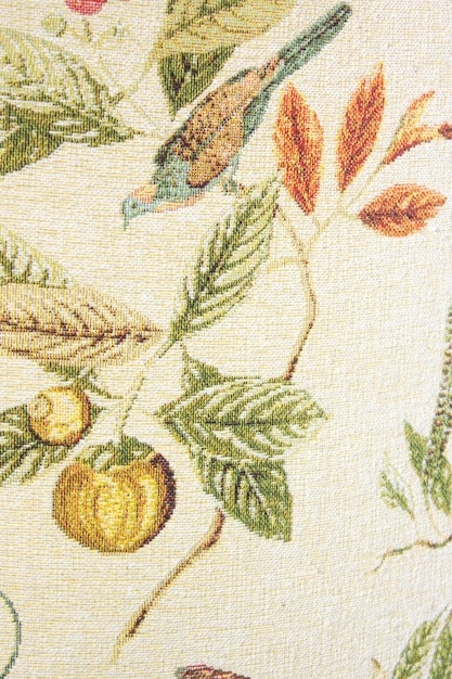 A close-up of a textile sample featuring a transitional cottagecore floral pattern. It combines traditional small floral motifs with slightly bolder, more abstract shapes, rendered in a sophisticated, earthy color palette with hints of unexpected vibrant green.