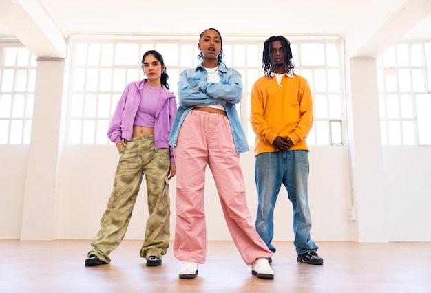 A diverse group of young individuals, dressed in modern interpretations of Y2K fashion, posing confidently in an urban setting. One is wearing a slightly wider leg low-rise jean with a fitted crop top.