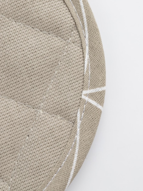 A detailed flat lay of a deconstructed puff sleeve showing the inner lining, precision stitching, and the sustainable fabric tag, emphasizing craftsmanship.