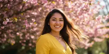 Woman with radiant, healthy hair confidently smiling amidst spring flowers.